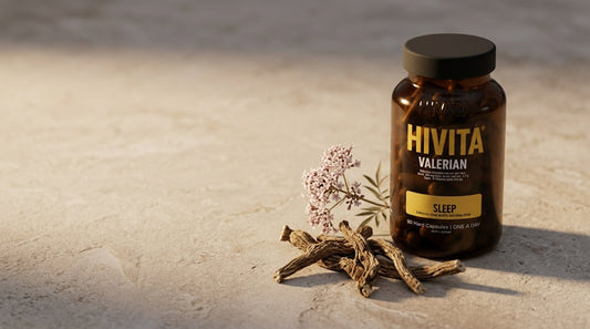 Hivita Valerian glass bottle beside dried valerian root and flowers in soft evening light